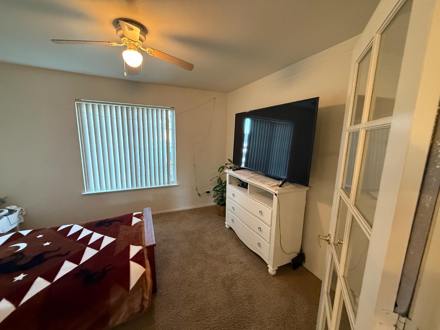 3124 Summer Lane Madera, CA 93637 - Photo 12 of 30 a bedroom with a bed and flat screen tv