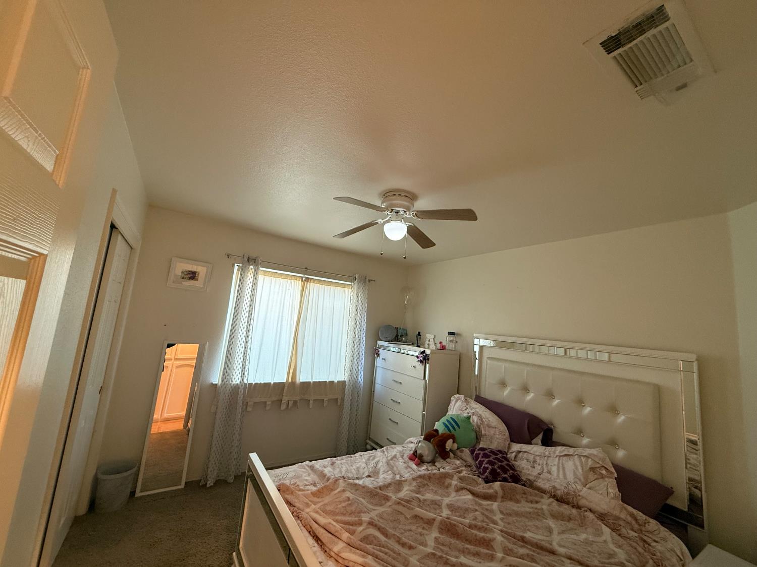 3124 Summer Lane Madera, CA 93637 - Photo 16 of 30 a bedroom with a bed and a mirror
