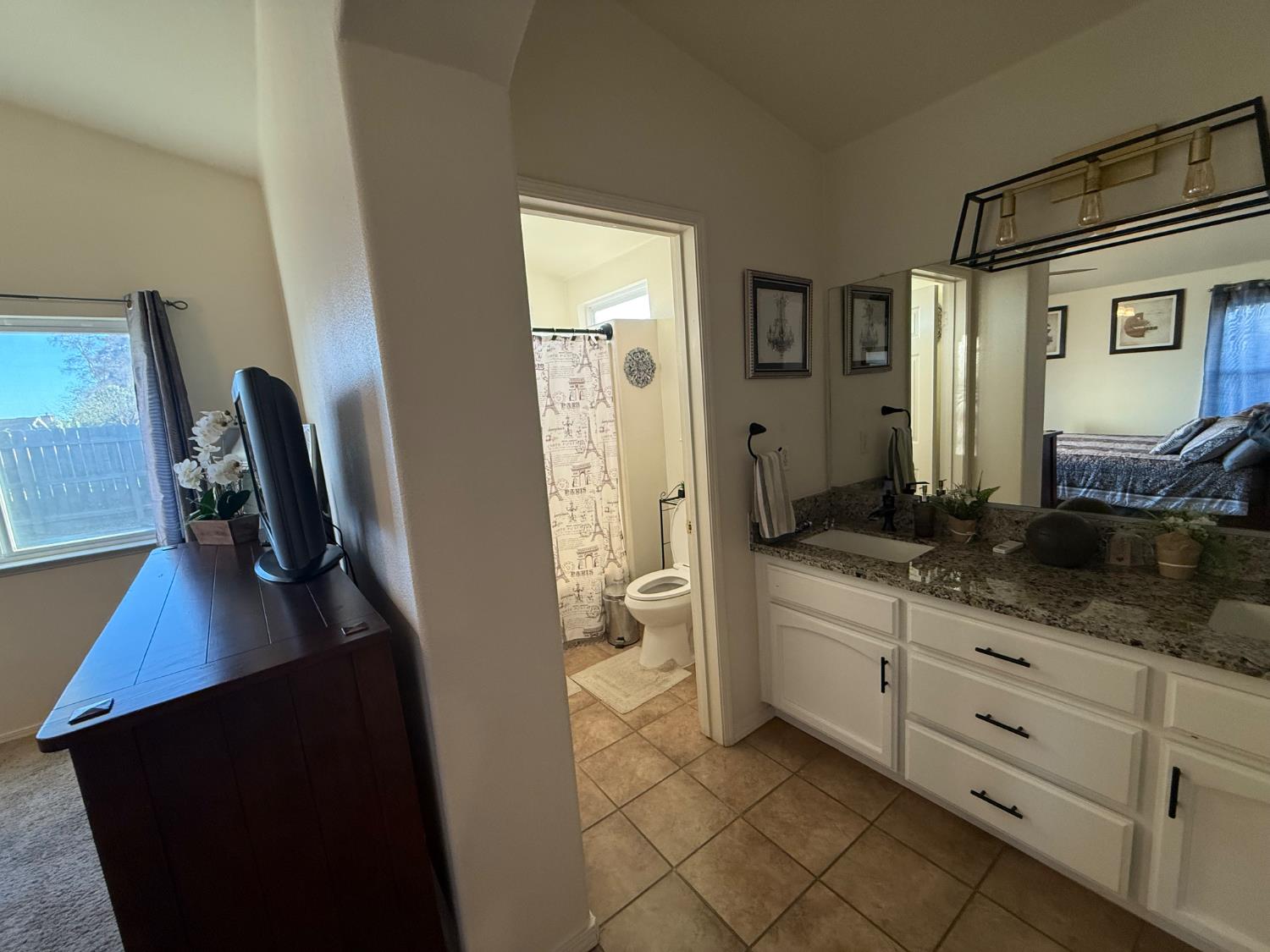 3124 Summer Lane Madera, CA 93637 - Photo 19 of 30 a bathroom with a double vanity sink a toilet a mirror and shower
