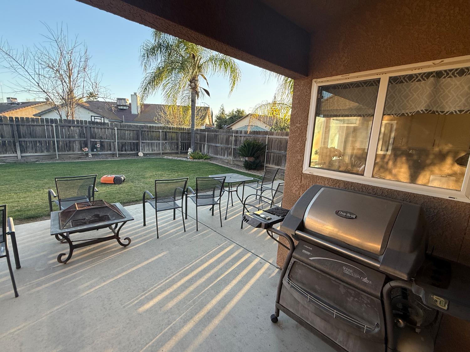 3124 Summer Lane Madera, CA 93637 - Photo 24 of 30 a roof deck with table and chairs a barbeque with potted plants