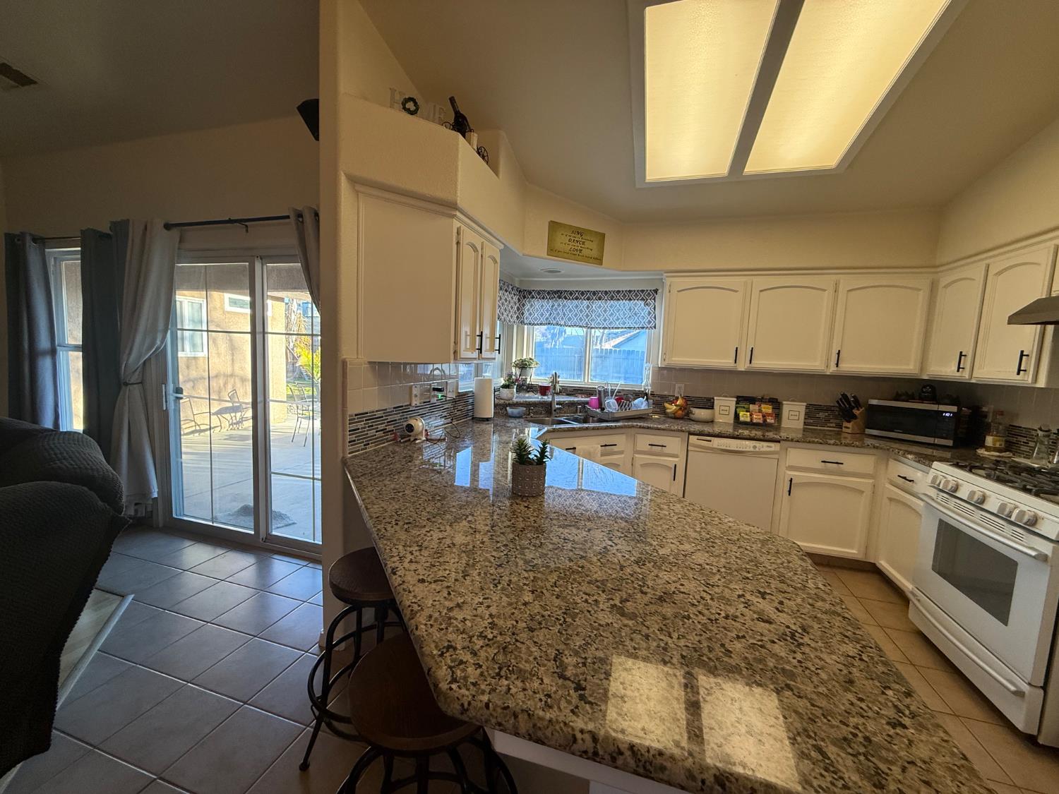 3124 Summer Lane Madera, CA 93637 - Photo 7 of 30 a kitchen with stainless steel appliances granite countertop a stove a sink and a granite counter tops