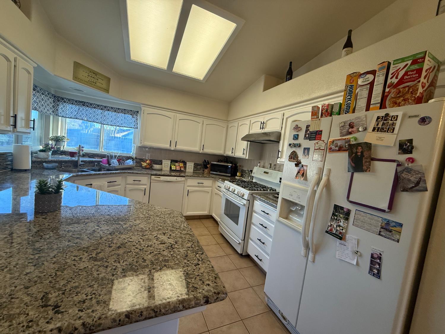 3124 Summer Lane Madera, CA 93637 - Photo 8 of 30 a kitchen with stainless steel appliances granite countertop a stove a sink and a refrigerator
