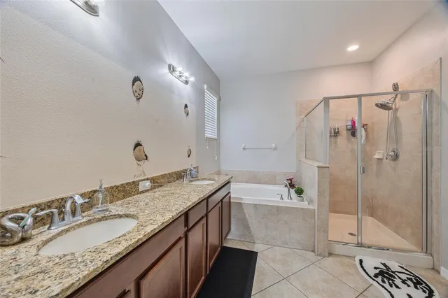 a bathroom with a granite countertop sink a mirror and a bathtub