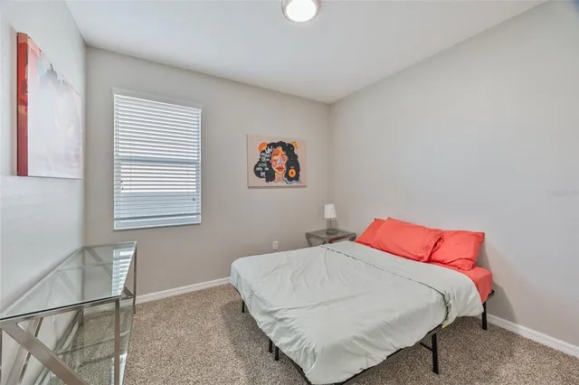 a bathroom with a granite countertop sink mirror vanity and toilet