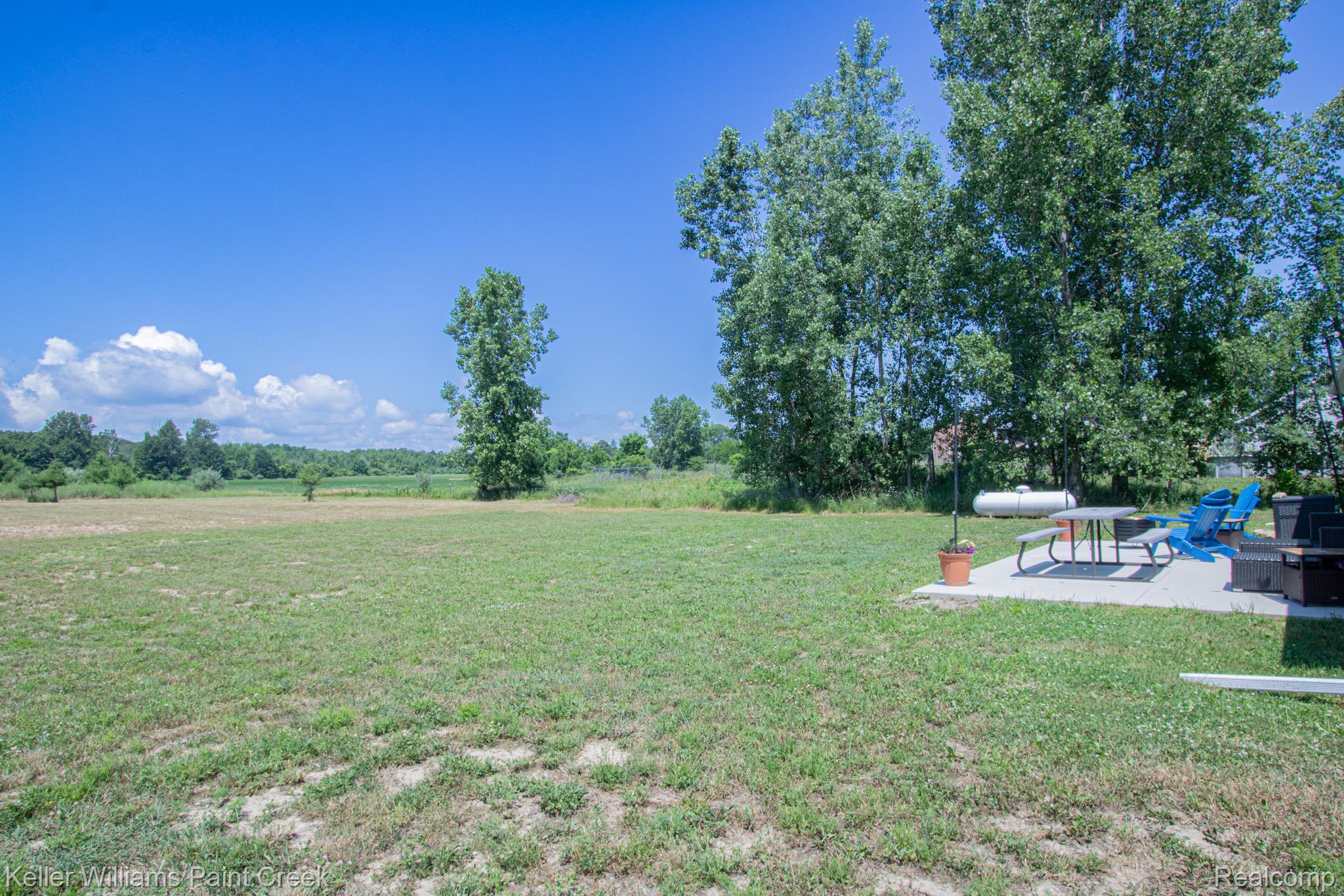 5200 Babcock Road Lexington, MI 48450 - Photo 26 of 31 Expansive grassy yard with a concrete patio