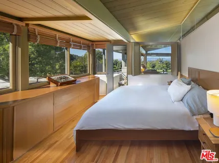 a bedroom with a large bed and a large window