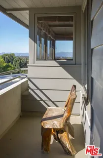 a view of a balcony with chairs