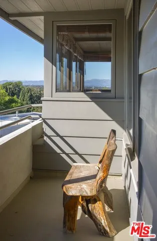 a view of a balcony with chairs