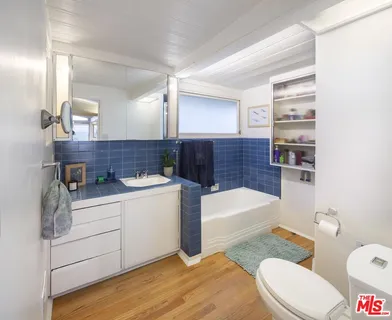 a bathroom with a sink a toilet and bathtub