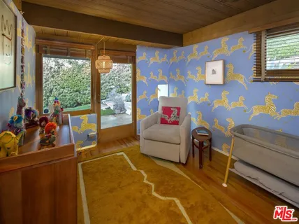 a living room with furniture and a floor to ceiling window