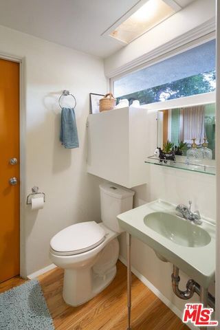 a bathroom with a sink toilet and mirror