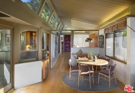 a dining room with furniture a chandelier and wooden floor