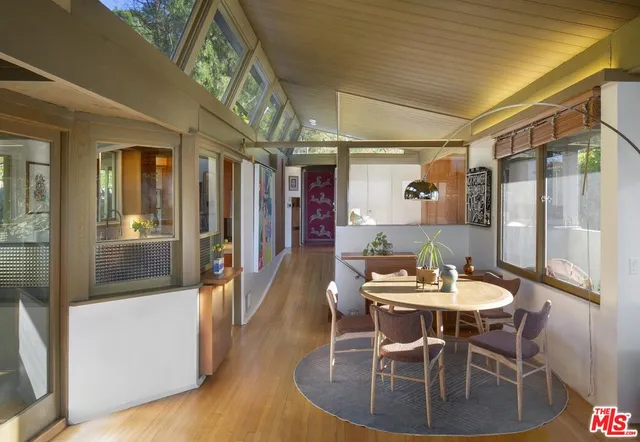 a dining room with furniture a chandelier and wooden floor