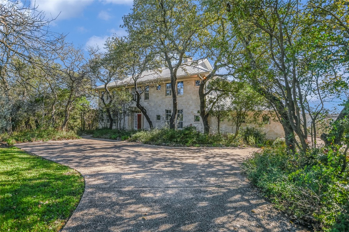 a pathway of a house with a yard