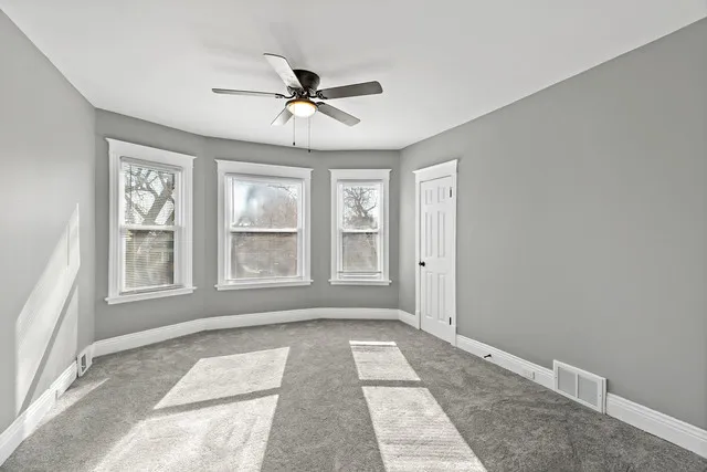 a bathroom with a toilet sink vanity and mirror