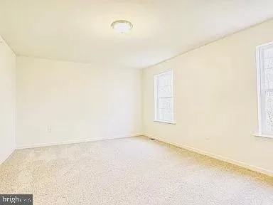 an empty room with a empty space and a window