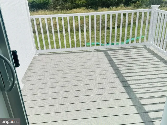a view of a house with a small yard and wooden fence