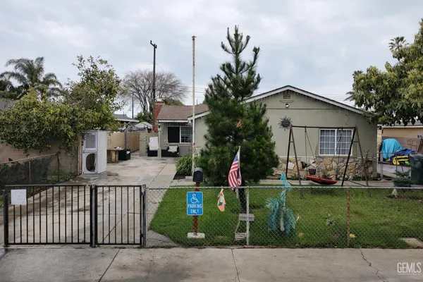 a front view of a house with a garden and plants