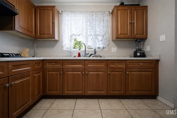 a kitchen with stainless steel appliances granite countertop a sink and cabinets