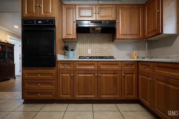 a kitchen with a refrigerator and cabinets