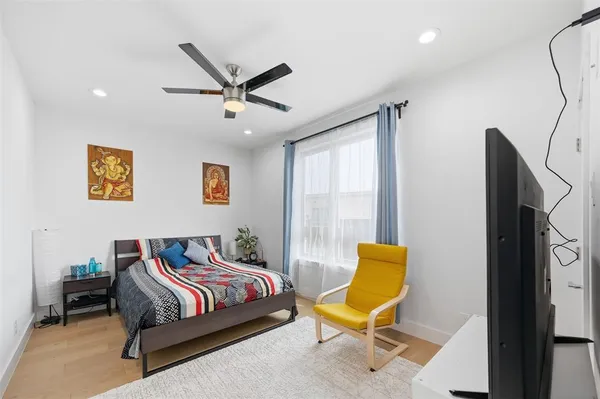 a bedroom with a bed and painting on the wall