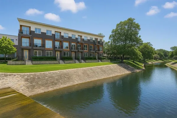 a view of building with river in front of it