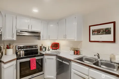 a kitchen with a sink stove and cabinets