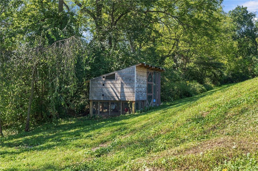 1255 Clearview Road Coplay, PA 18037 - Photo 52 of 54 A rustic outbuilding sits nestled among mature trees on a grassy hillside.