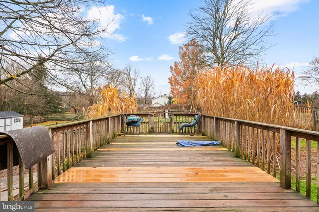 a view of a balcony with wooden floor and fence