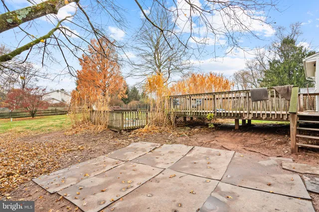 a view of a yard with wooden fence