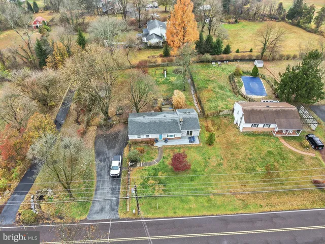 an aerial view of residential houses with outdoor space and swimming pool