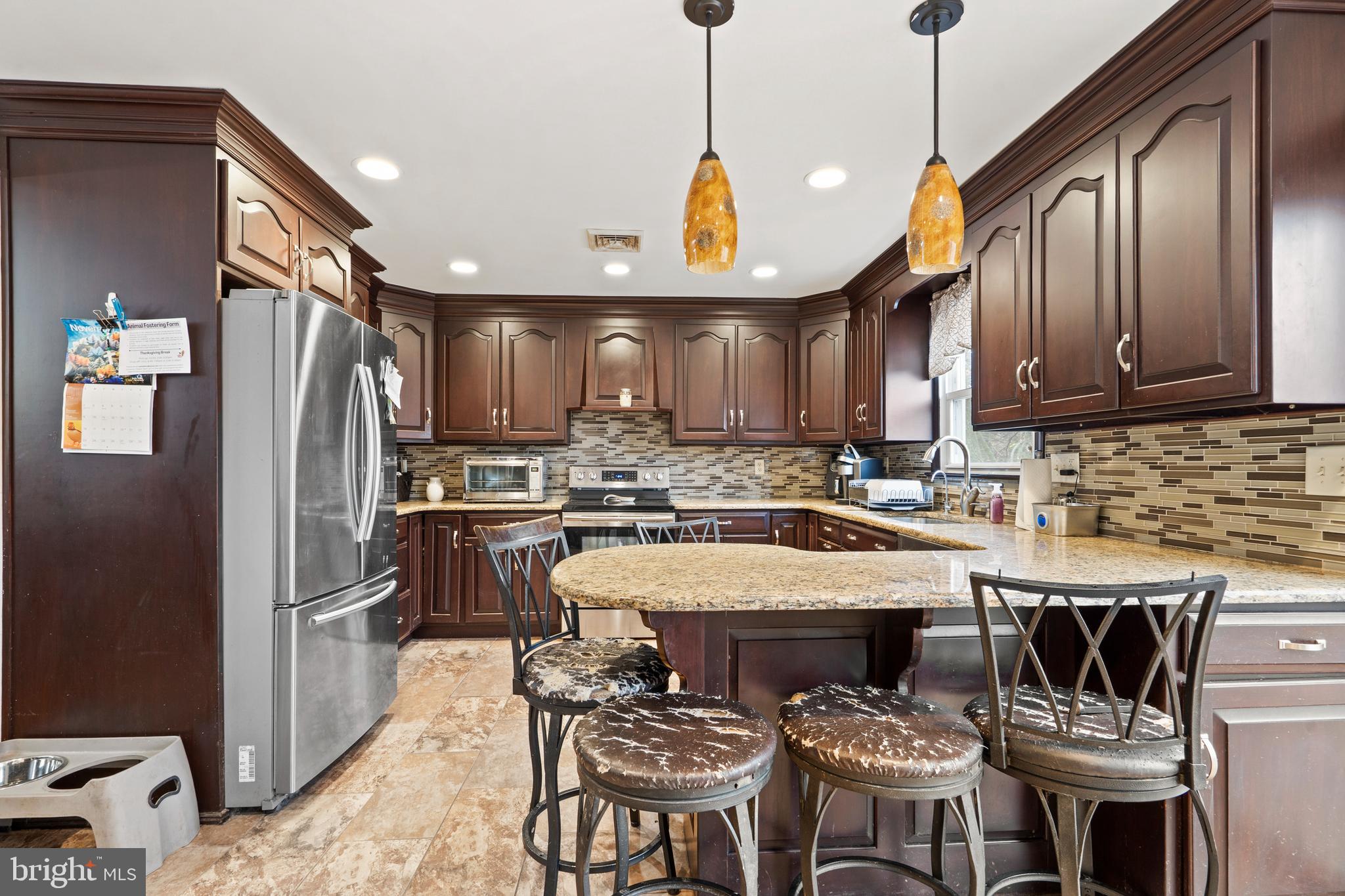 1538 Temple Road Pottstown, PA 19465 - Photo 7 of 29 a kitchen with stainless steel appliances granite countertop a sink a stove a refrigerator cabinets a dining table and chairs