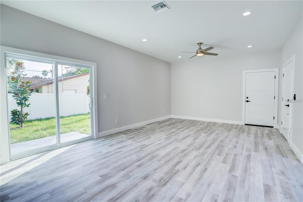 5630 Queener Avenue Port Richey, FL 34668 - Photo 19 of 37 wooden floor in an empty room with a window