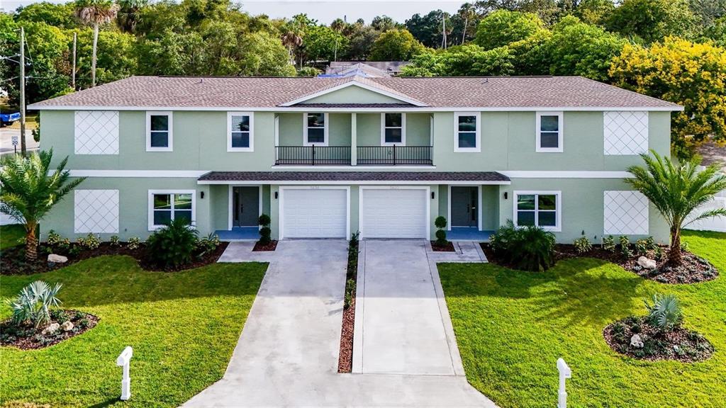 5630 Queener Avenue Port Richey, FL 34668 - Photo 2 of 37 a front view of a house with a yard and potted plants