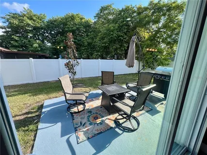 a patio with table and chairs