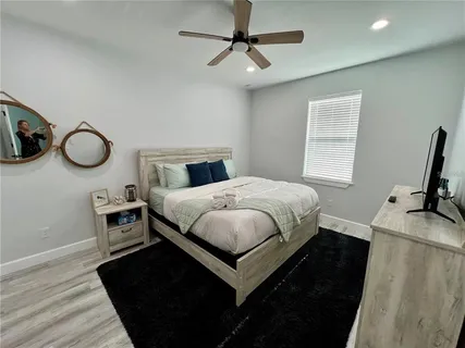a bedroom with a bed and a chandelier