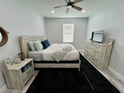 a bedroom with a bed and a tv