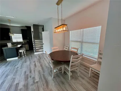 a view of a dining room with furniture window and wooden floor