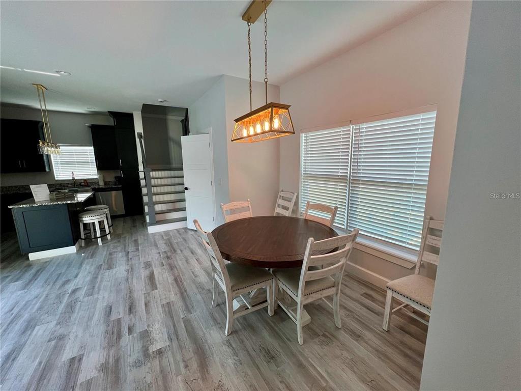 5630 Queener Avenue Port Richey, FL 34668 - Photo 9 of 37 a view of a dining room with furniture window and wooden floor