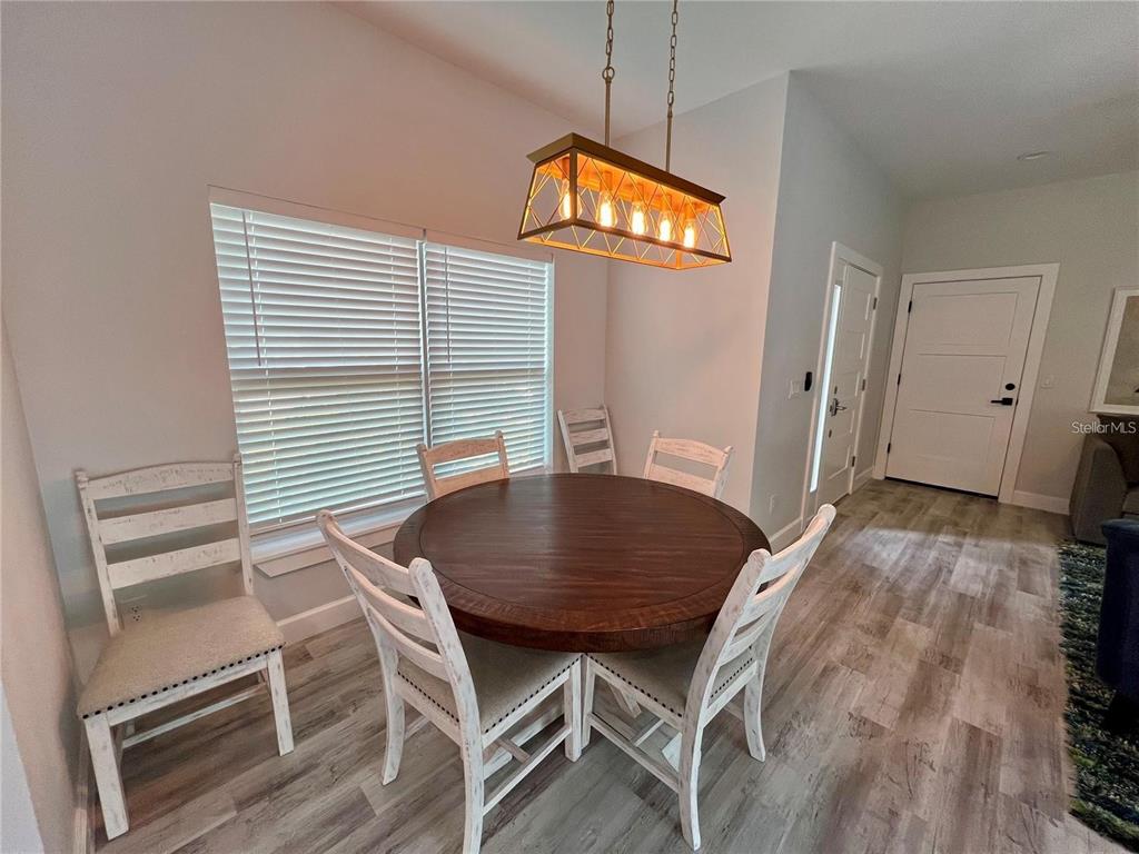 5630 Queener Avenue Port Richey, FL 34668 - Photo 10 of 37 a view of a dining room with furniture and wooden floor