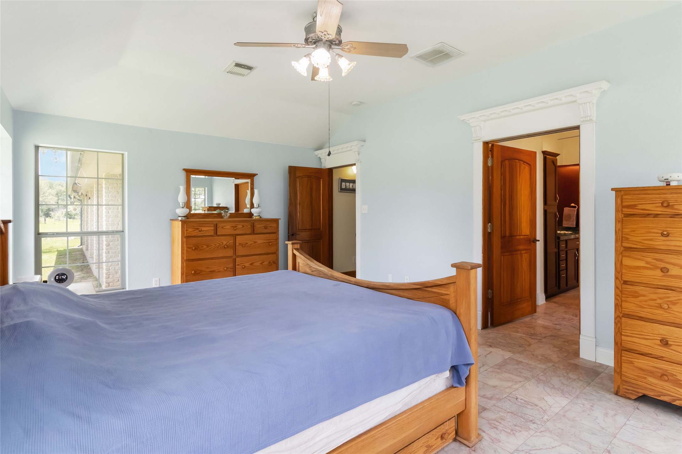 1208 Jeddo Road Rosanky, TX 78953 - Photo 12 of 40 Relax in this tranquil bedroom, featuring a generous window and elegant flooring.