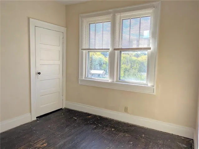 an empty room with windows and entrance