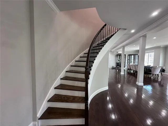 a view of entryway and hall with wooden floor
