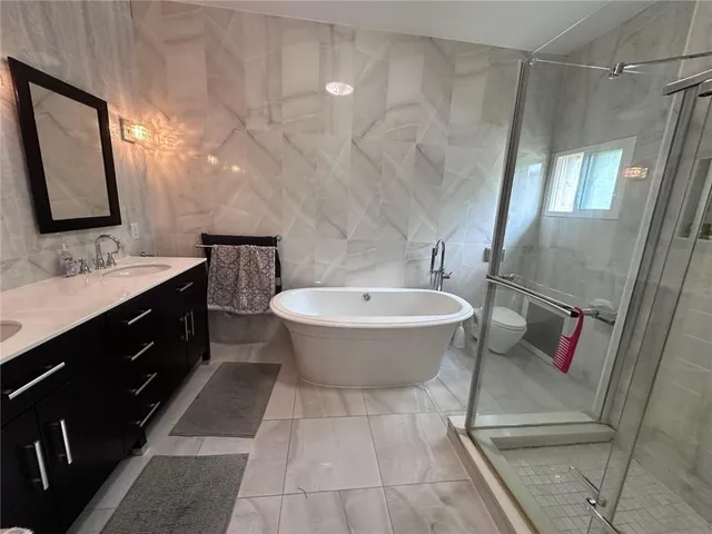 a bathroom with a sink toilet and shower