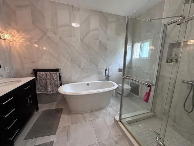 a bathroom with a bathtub and a shower