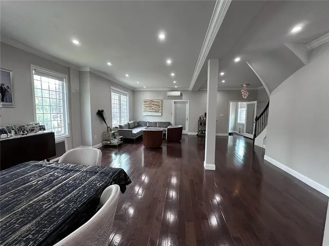 a bedroom with a large bed and wooden floor
