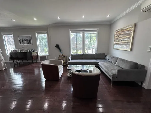 a living room with furniture window and wooden floor