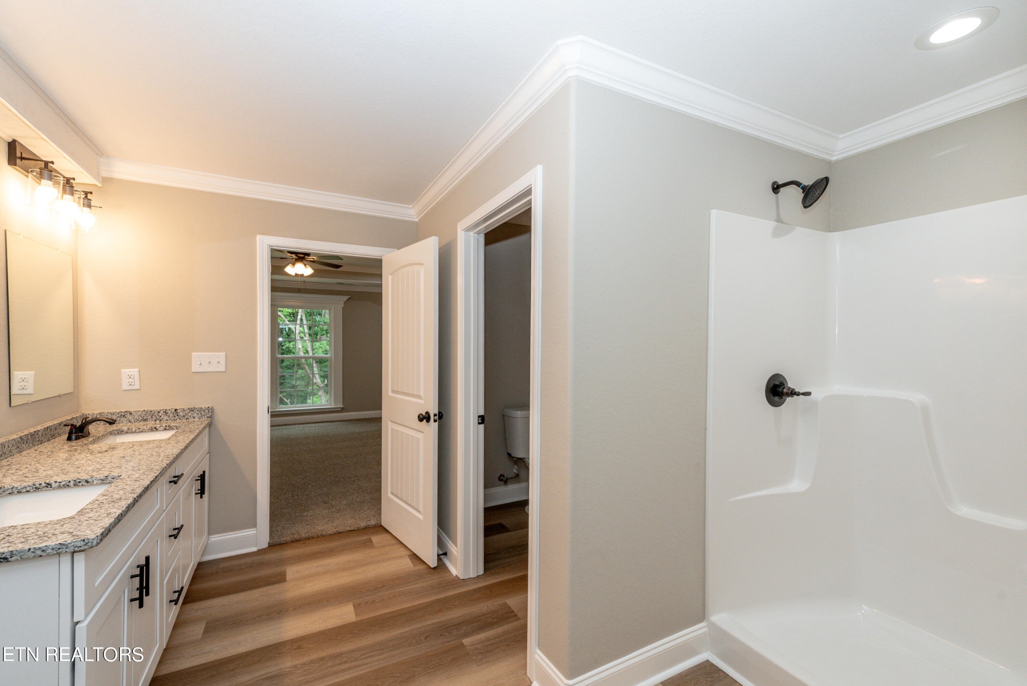3650 Big Springs Road Friendsville, TN 37737 - Photo 21 of 26 a bathroom with a granite countertop sink a mirror and a shower