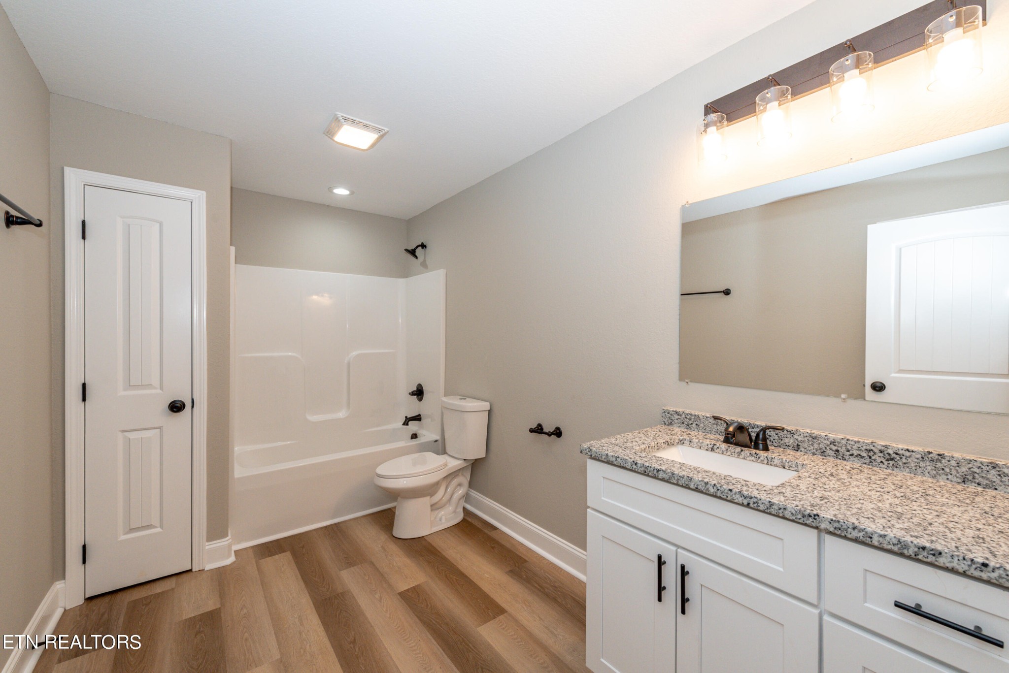 3650 Big Springs Road Friendsville, TN 37737 - Photo 24 of 26 a bathroom with a granite countertop sink a toilet and shower