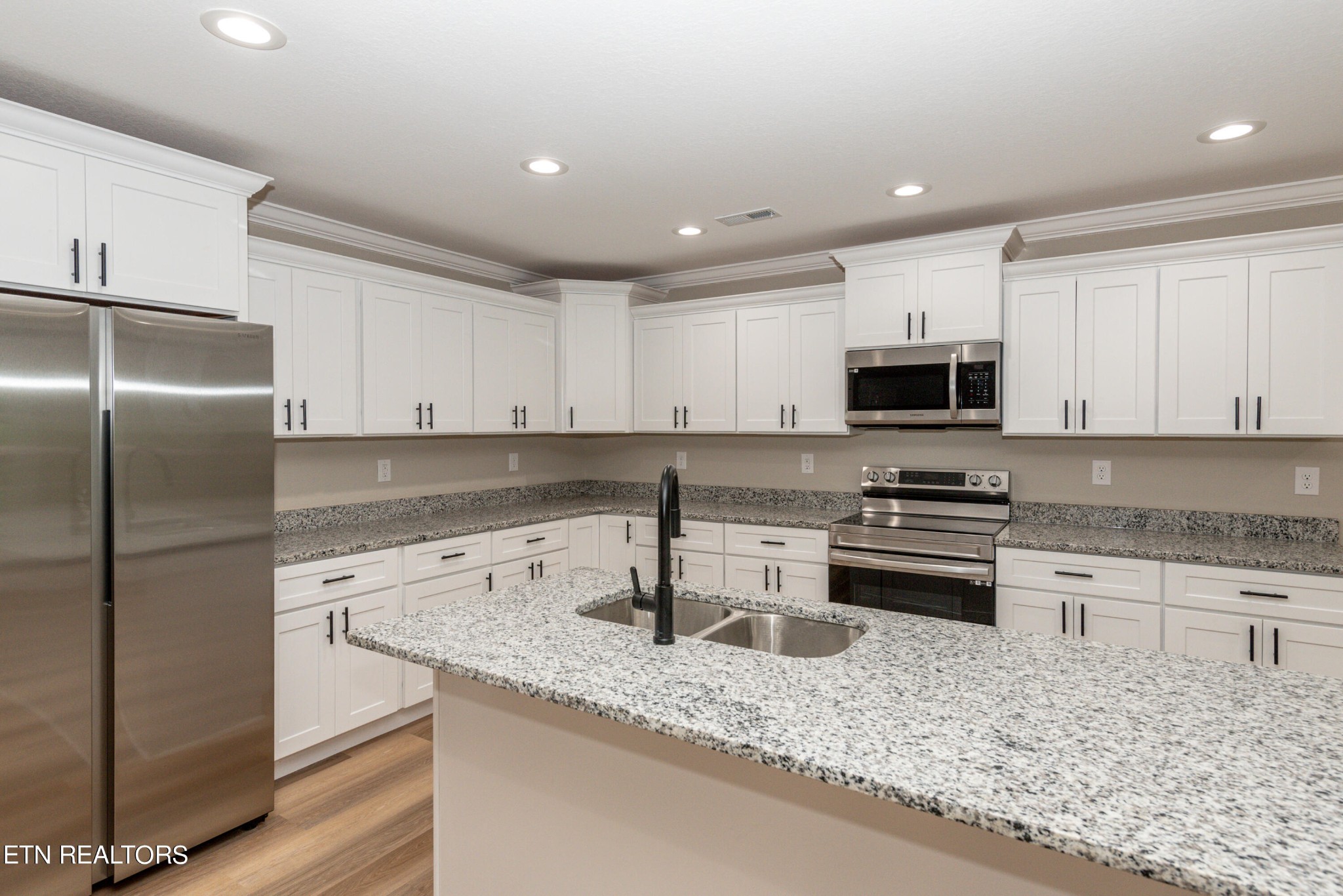 3650 Big Springs Road Friendsville, TN 37737 - Photo 9 of 26 a kitchen with stainless steel appliances granite countertop a sink stove and refrigerator